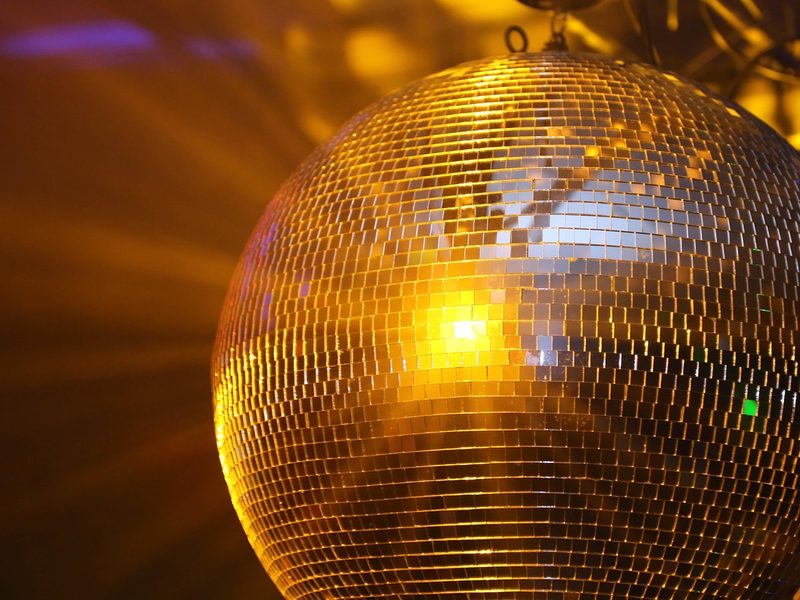 Golden disco ball spinning above the dance floor