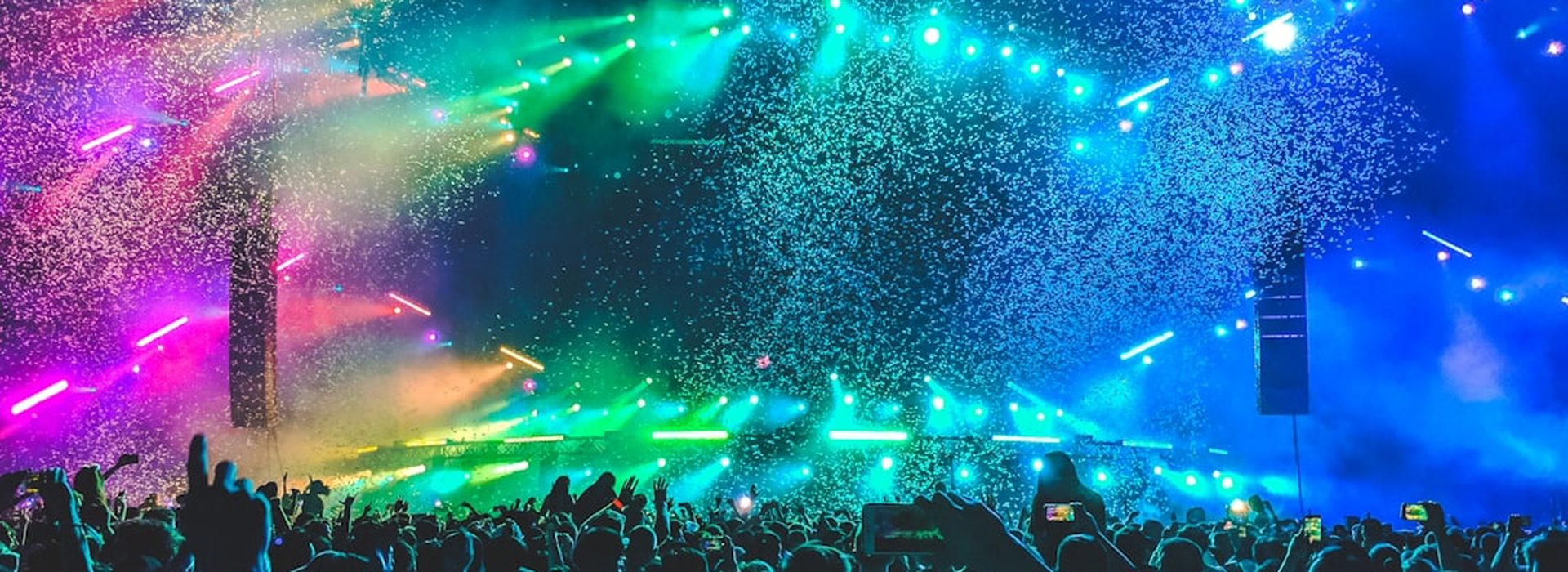 Confetti falling over a colourful concert crowd